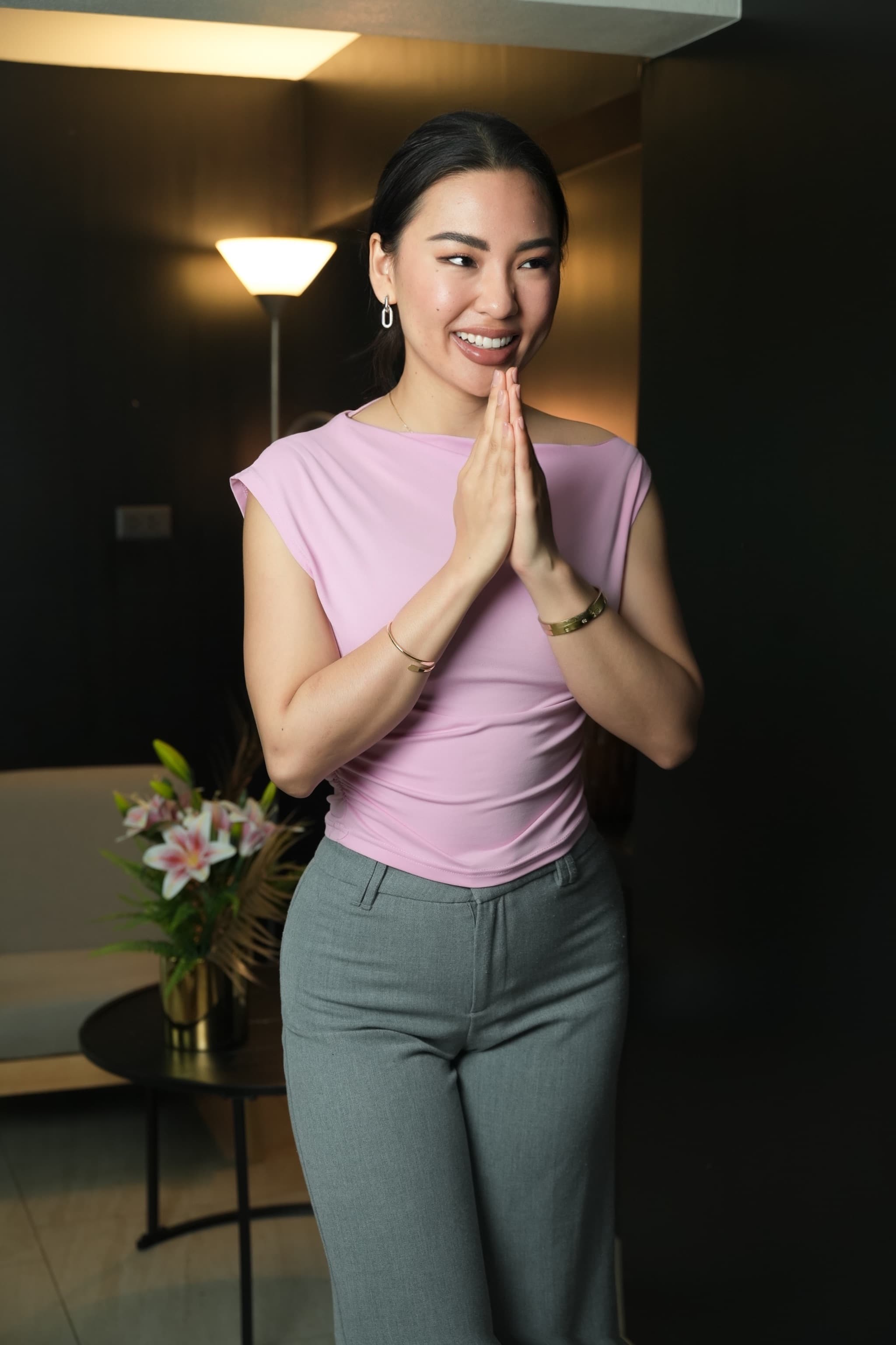 Thai person performing the Wai greeting with hands pressed together